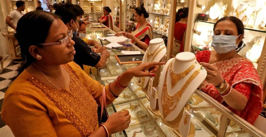 People buying gold jewelry and coins on Dhanteras 2025 for prosperity and good fortune
