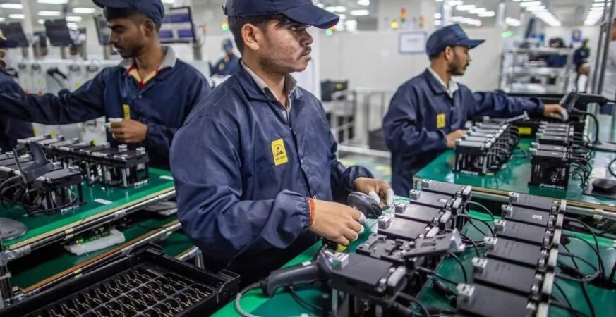 Indian workers assembling electronic components in a manufacturing unit