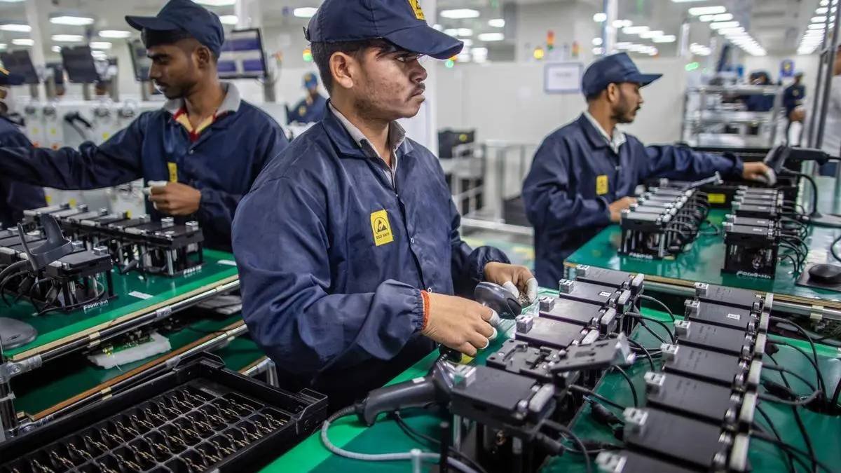 Indian workers assembling electronic components in a manufacturing unit