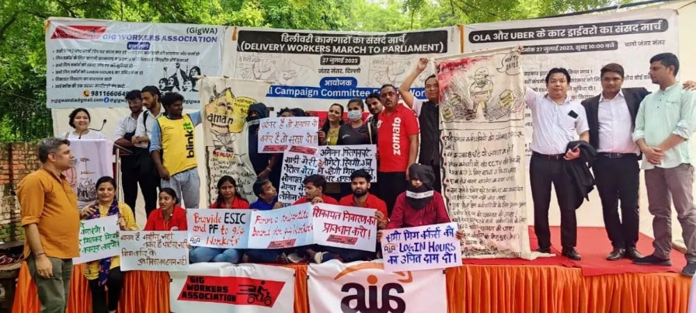 Indian gig worker holding delivery bag during protest over low wages