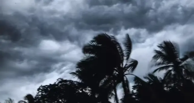 Cyclone Montha approaching Andhra Pradesh coast near Kakinada with dark storm clouds over Bay of Bengal