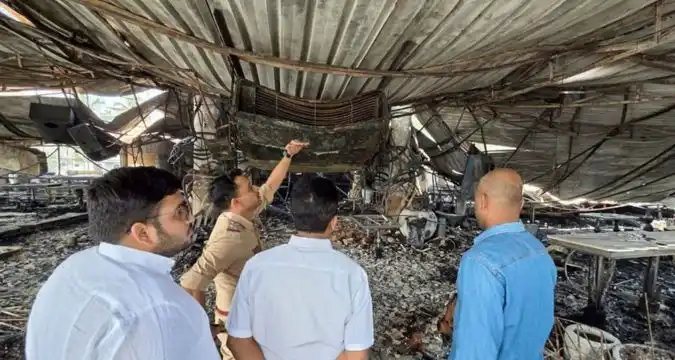 Police and forensic teams inspecting the burnt interiors of the nightclub in Goa
