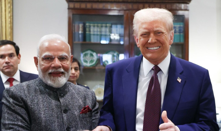 Prime Minister Modi and President Trump sharing a handshake at the White House