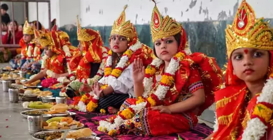 Women performing Pushpanjali and Kanya Puja rituals on Durga Ashtami 2025 in India