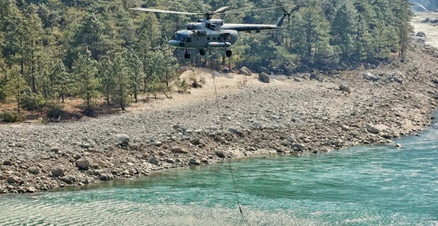 Indian Air Force helicopter conducting firefighting operations during forest fire in Arunachal Pradesh