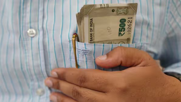 Indian office worker stressed about job security and financial responsibilities