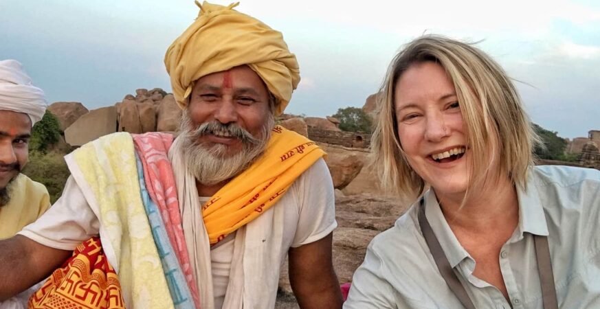 Travelers sharing stories and meals with locals in a rural village, representing empathy and cultural exchange through travel.