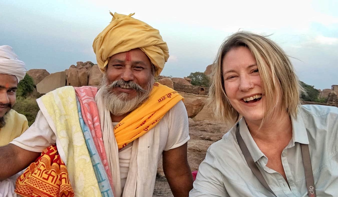 Travelers sharing stories and meals with locals in a rural village, representing empathy and cultural exchange through travel.