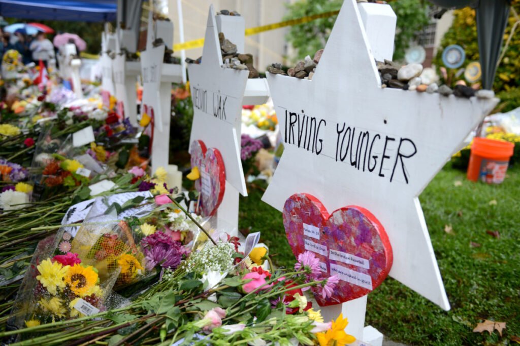 Flowers and candles mark remembrance for victims of violence against Jewish people across regions.